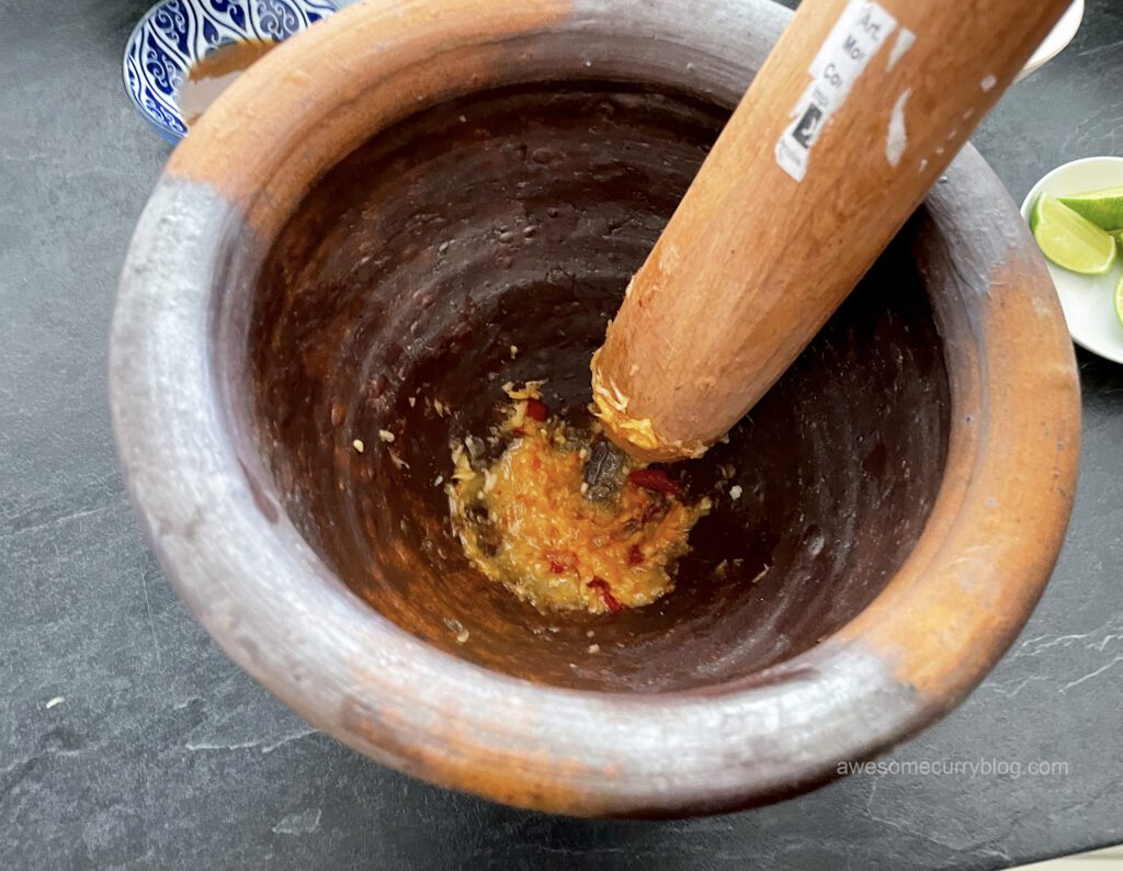процесс приготовления папайя салата в традиционной тайской ступке
