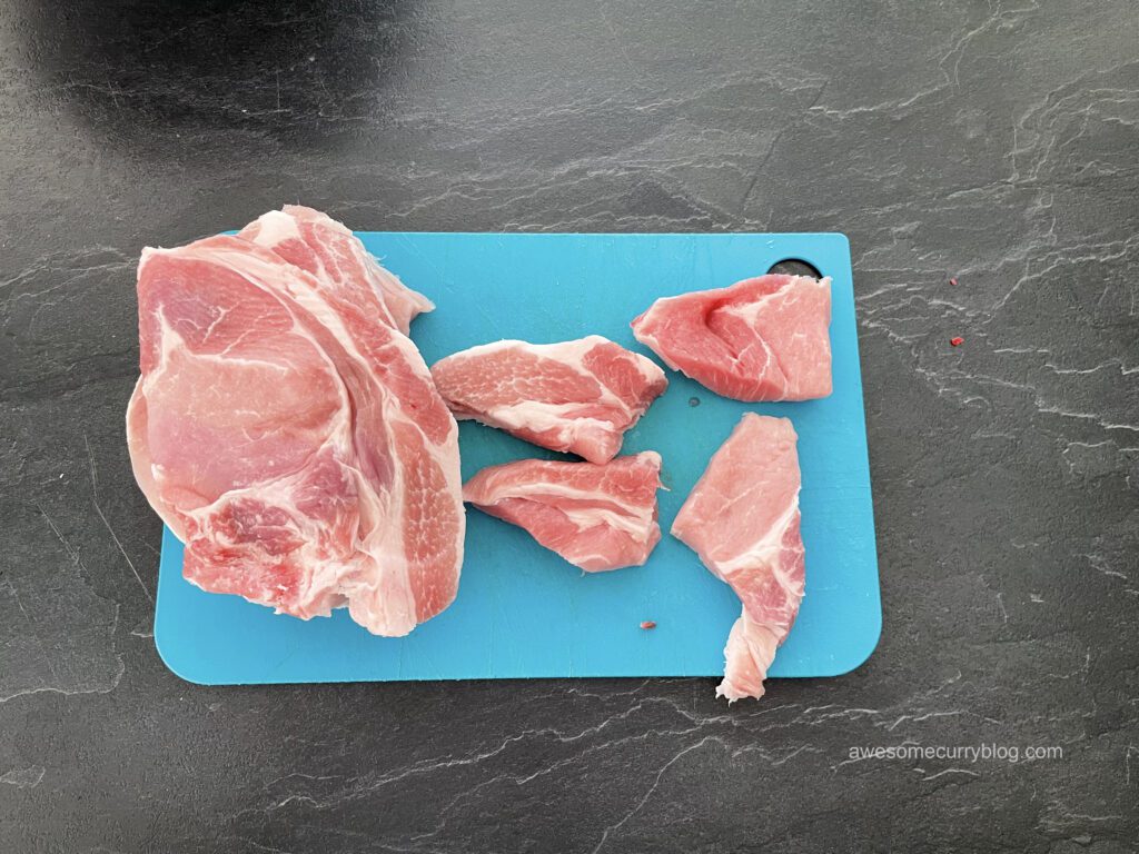 pork, cut for satay, on the cutting board