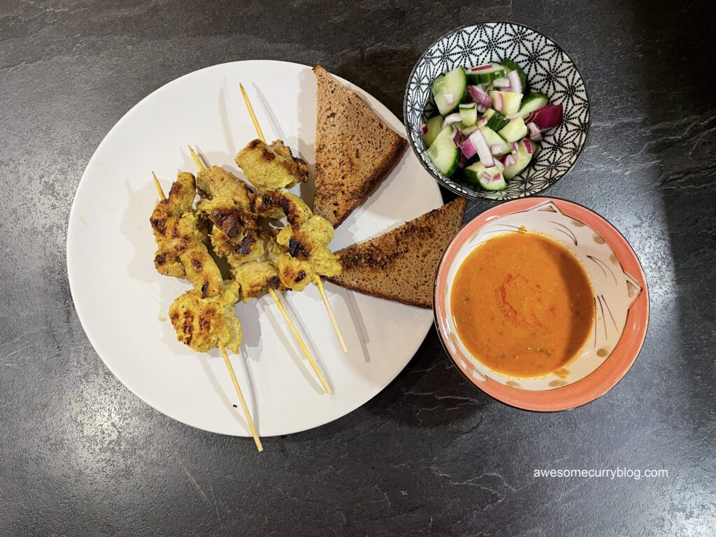 plated thai satay from pork with peanut sauce and salad