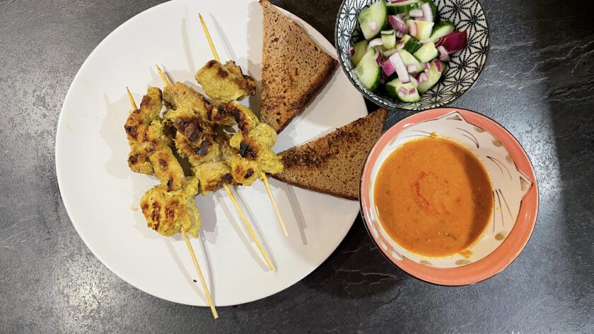 plated thai satay from pork with peanut sauce and salad